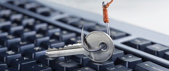 phishing, hacking personal data and money , key and hook on computer keyboard.