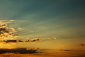 Fototapeta na wymiar Colorful sunset sky sun rays passing clouds, red tones sunset