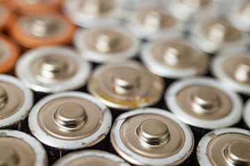 many batteries stacked, soft focus