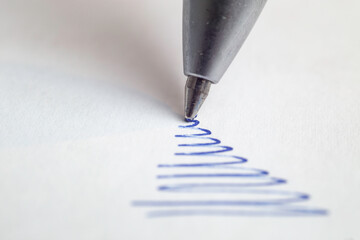 Blue ink ball pen scribbling on white paper,