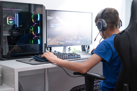 a teenager plays video games on a computer gaming, video game addiction in adolescence