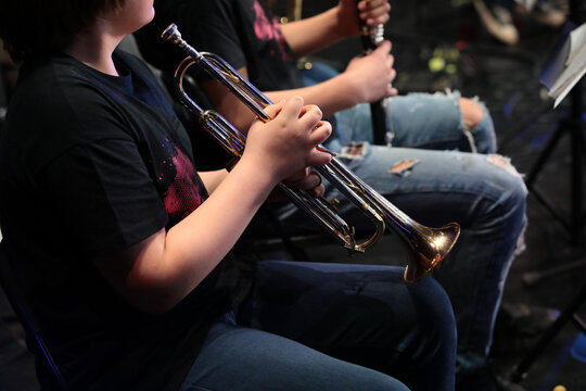 A person playing the trumpet by notes sitting in a jazz orchestra a close-up view of a musician blowing into a musical instrument.Image concept leisure and creative hobby of teenagers