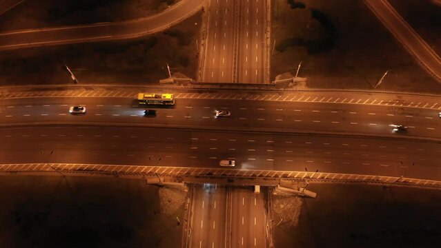 Paton Bridge in Kyiv at night, Ukraine. Aerial view. Car traffic on bridge. Circular movement of cars. Night. 