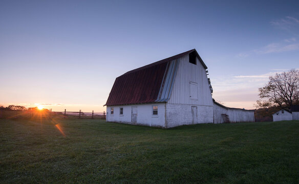 Sunrise over a barn at Sky Meadows State Park in Delaplane, Virginia in autumn.