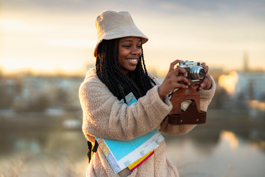 Tourist African American Woman With Camera Taking Photos Of Beautiful Location, She's Happy And Excited About Visiting New City