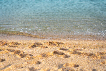 Human footprint on sand summer beach background with copyspace