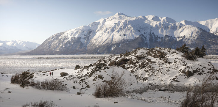 People walking along the rocky outpost of Beluga Point at Turnagain Arm in early spring, Alaska, USA