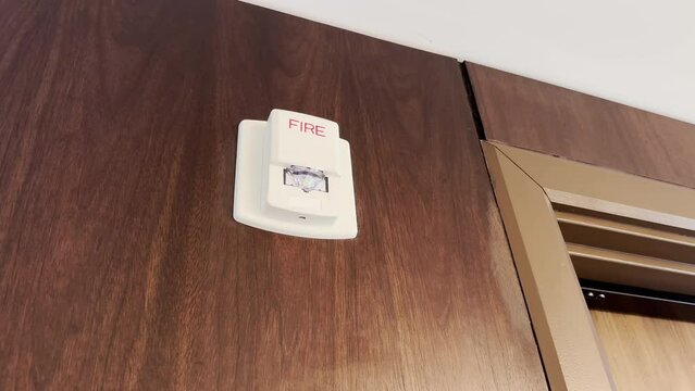 A close up shot of a commercial fire alarm flashing on the wall. Looping.	