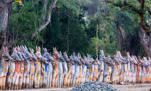 Row of painted, terracotta horse statues at the Sri Solai Andavar Temple in Kothari, Chetinadu Region, Tamil Nadu, India