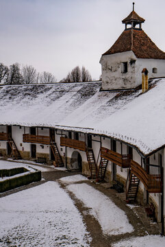Defensive walls and living accommodations of the fortified Gothic Saxon Church of Saint Nicolas of Harman (Honigberg) in winter, near Brasov, Transylvania, Romania; Brasov, Transylvania, Romania