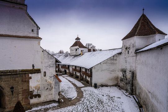 Defensive walls and living accommodations of the fortified Gothic Saxon Church of Saint Nicolas of Harman (Honigberg) in winter, near Brasov, Transylvania, Romania; Brasov, Transylvania, Romania