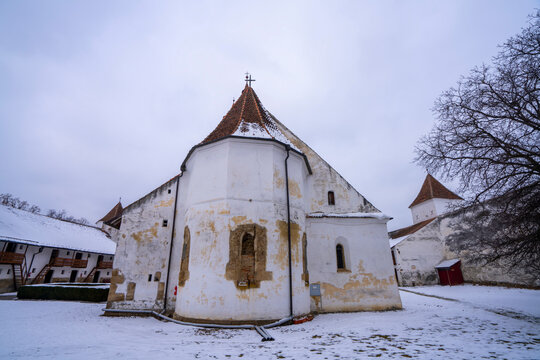 Defensive walls and living accommodations of the fortified Gothic Saxon Church of Saint Nicolas of Harman (Honigberg) in winter, near Brasov, Transylvania, Romania; Brasov, Transylvania, Romania