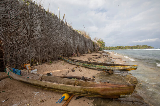 Woven sago palm wall and canoes, Tuam Island, Siassi Islands, Vitiaz Strait, Papua New Guinea