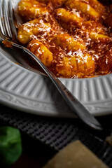Gnocchi pasta with marinara sauce, garnished with fresh basil and parmesan cheese
.