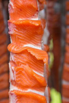 Close-up detail of filleted salmon hanging on a drying rack in a smoke house at a remote fish camp in summer, Kuskokwim River; Kalskag, Alaska, United States of America