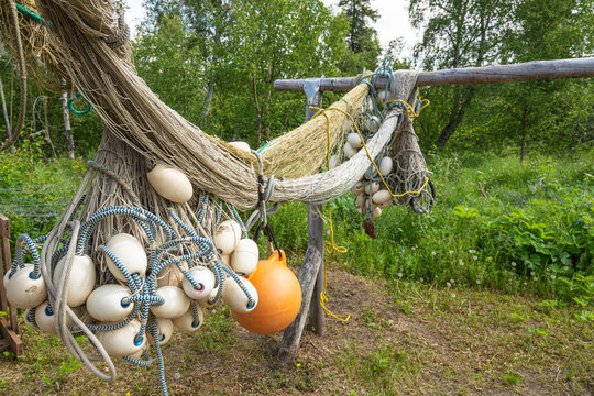 Salmon drift nets with floats and buoy hung up to dry at a remote fish camp in summer, Kuskokwim River; Kalskag, Southwestern Alaska, Alaska, United States of America