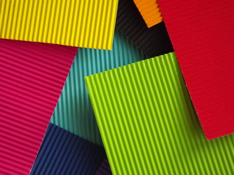 The corrugated surface is multicolored with parallel lines as a background black blue orange crimson pink light green orange and purple