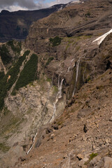 Alpine landscape. View of glacier Castaño Overo melting ice creating cascades in Tronador hill rocky environment.