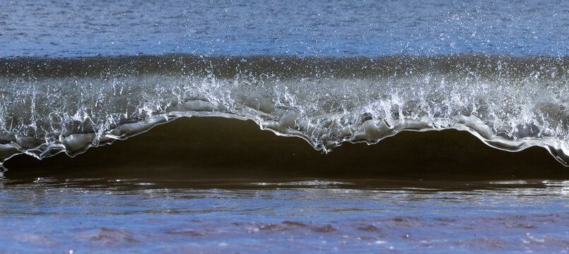 Close-up detail of an approaching wave breaking at the shore; South Shields, Tyne and Wear, England