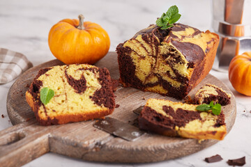 Fototapeta na wymiar Pound marble cake with chocolate and pumpkin layers. Delicious homemade dessert. 