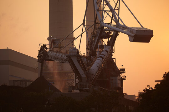 A silhouette of a coal-fired power station at sunset, Lamma Island, Hong Kong.; Yung Shue Wan, Lamma Island, Hong Kong, China.