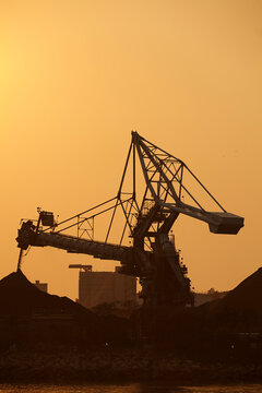 A silhouette of a coal-fired power station at sunset, Lamma Island, Hong Kong.; Yung Shue Wan, Lamma Island, Hong Kong, China.