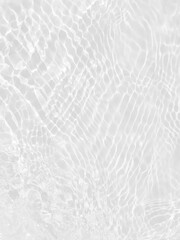 Defocus blurred transparent white colored clear calm water surface texture with splashes and bubbles. Trendy abstract nature background. Water waves in sunlight with copy space. White water shine