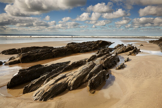 Rocks and pools on a beach at low tide, at Saunton Sands, Devon, England, Great Britain.; Saunton Sands, Braunton, Barnstaple, north Devon, southwest England, Great Britain, United Kingdom.