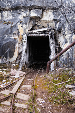 Old train tracks leading into an abandoned mine tunnel into the mountains near Nabesna; Alaska, United States of America