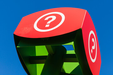 Red question mark sign against a blue sky at a tourist information centre; Mont-Tremblant, Quebec, Canada