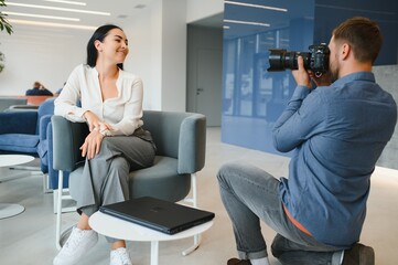 Young beautiful model posing for professional photographer in studio.