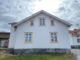 A view of red wooden houses on Vrango Archipelago island .