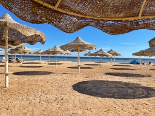 Beach with chaise longue and sand.