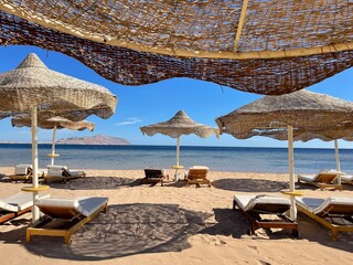 Beach with chaise longue and sand.