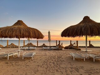 Beach with chaise longue and sand.
