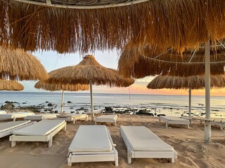 Beach with chaise longue and sand.