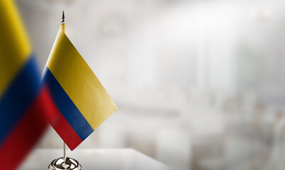 Small flags of the Colombia on an abstract blurry background