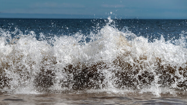 Close-up detail of the surf breaking and splashing at the shore; South Shields, Tyne and Wear, England