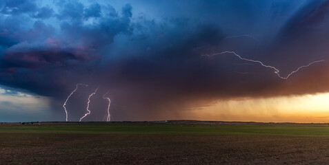 Lightning strikes from a weak airmass thunderstorm at sunset in the Texas Panhandle; Texas, United States of America