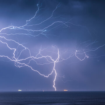 A crazy bolt of lightning lights up the sky over the English Channel; Brighton, East Sussex, England