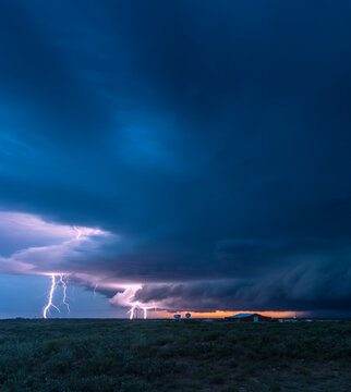 Lightning strikes from a supercell thunderstorm over the oil fields of New Mexico one evening; Maljamar, New Mexico, United States of America