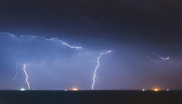 A spectacular lightning bolt strikes at the Rampion Offshore WIndfarm in the English Channel near Brighton on the south coast of the United Kingdom; Brighton, East Sussex, England
