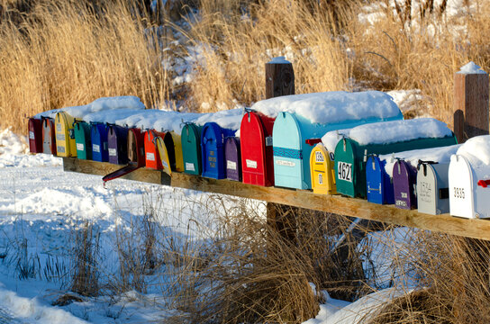 Close-up of a row of colorful mailboxes on a subdivision road in Homer; Homer, Alaska, United States of America