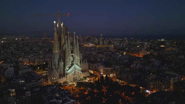 Evening flying past Sagrada Familia towards downtown Barcelona