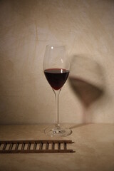still life of glass of red wine and ladder