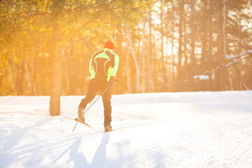 Cross country skiing in winter on snowy track, sunset background, habits for lifestyle