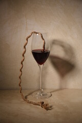 crystal glass of red wine with rope for climbing