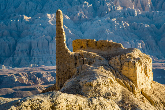 Ruins and limestone rock formations in the mountainous landscape around the Sutlej Valley near the Guge Kingdom with Himalayas in background; Tsaparang, Zanda, Tibetan Autonomous Region, Tibet