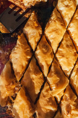 glass pan of homemade middle eastern baklava cut into diamond shapes