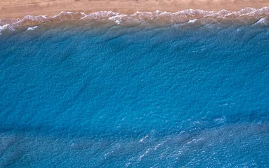 Fototapeten Concept summer sunny travel image. Turquoise water wave with sand beach background from aerial top view © Parilov